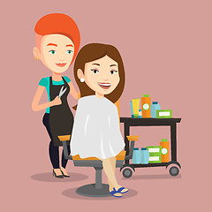 Image showing Hairdresser making haircut to young woman.