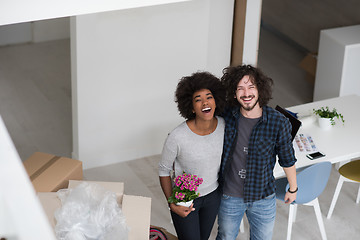 Image showing multiethnic couple moving into a new home