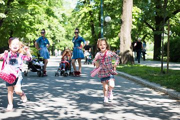 Image showing twins mother with children  in city park