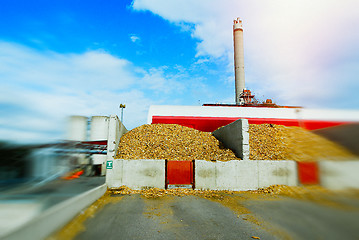Image showing blurred bio power plant with storage of wooden fuel (biomass) ag