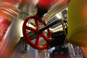 Image showing industrial factory worker turning red wheel of valve