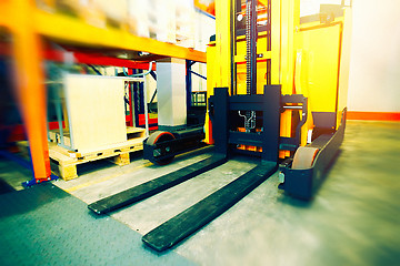 Image showing Shelves, racks and forklift blured with pallets in distribution 