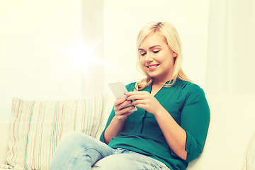 Image showing happy woman with smartphone at home