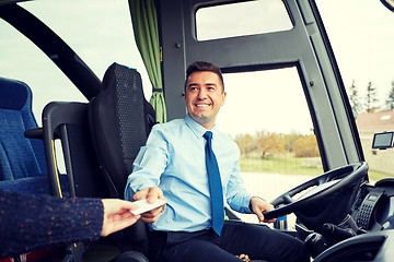 Image showing bus driver taking ticket or card from passenger