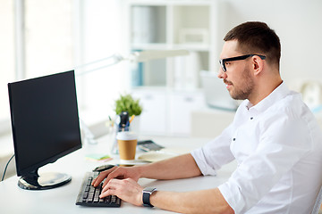 Image showing businessman typing on computer keyboard at office