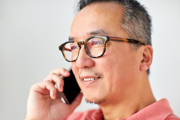 Image showing close up of man calling on smartphone at home