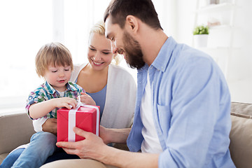 Image showing happy family with birthday gift at home