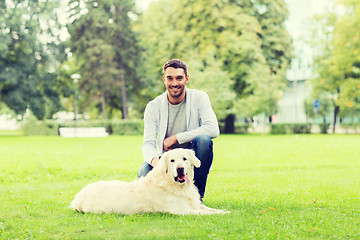 Image showing happy man with labrador dog walking in city