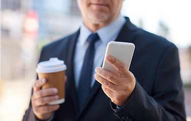 Image showing senior businessman with smartphone and coffee