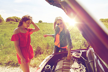 Image showing women with open hood of broken car at countryside