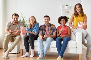 Image showing happy friends with popcorn and beer at home