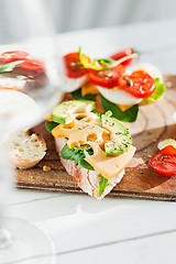 Image showing The baguette and cheese on wooden background