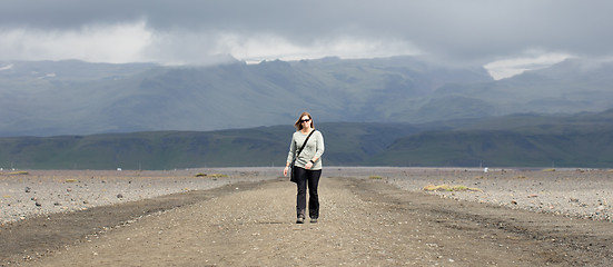 Image showing Woman hiker walking in mountain landscape