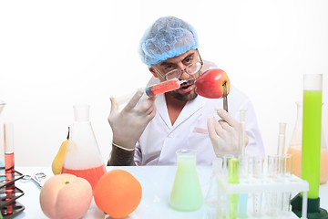 Image showing scientist fills chemicals fruit and vegetables