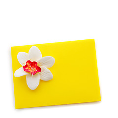 Image showing Close up of yellow envelope with flower