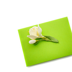 Image showing Close up of green envelope with flower