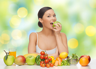 Image showing woman with fruits and vegetables eating apple