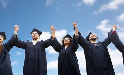 Image showing happy students or bachelors celebrating graduation