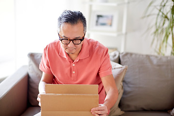 Image showing man opening parcel box at home