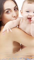 Image showing baby boy and beautiful mama in water