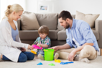 Image showing happy family playing with beach toys at home