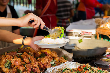 Image showing seller with rice and wok food at street market