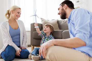 Image showing happy family playing with toy wind turbine