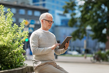 Image showing senior man with tablet pc on city street