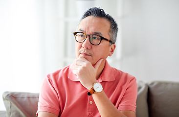 Image showing asian man thinking at home