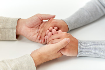 Image showing close up of old man and young woman holding hands