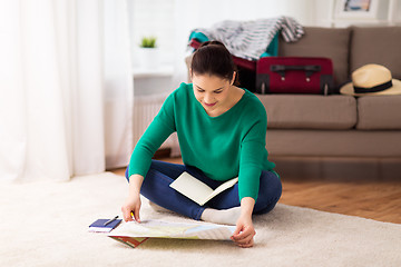 Image showing woman with map planning her travel at home