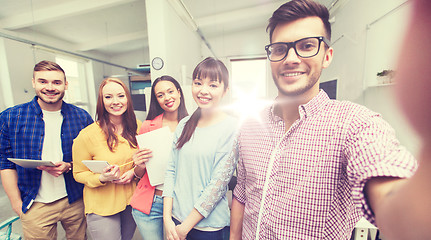 Image showing creative business team taking selfie at office