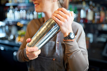 Image showing close up of bartender with cocktail shaker at bar