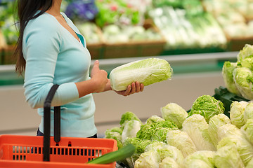 Image showing woman with basket and chinese cabbage at grocery