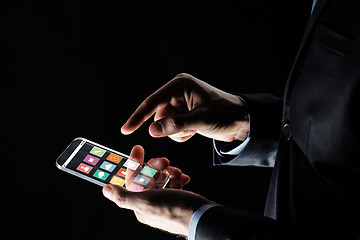 Image showing close up of businessman hand with glass smartphone