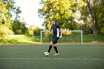 Image showing soccer player playing with ball on football field