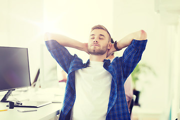 Image showing happy creative man with computer at office