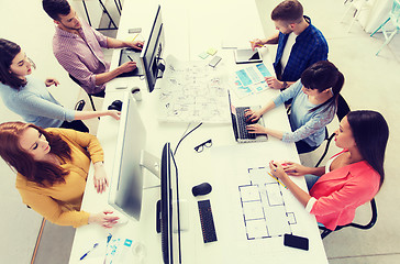 Image showing creative team with computers, blueprint at office