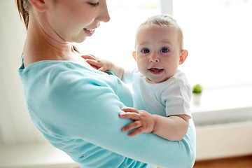 Image showing happy young mother with little baby at home