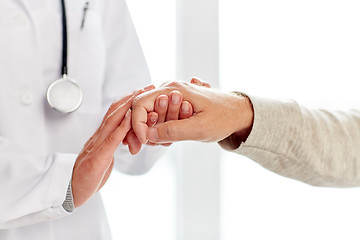 Image showing close up of doctor holding old man hand