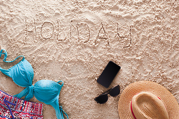 Image showing Holiday written in a sandy tropical beach