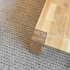 Image showing Wooden table on gray knitted carpet