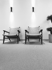 Image showing Black and white interior with rattan chairs