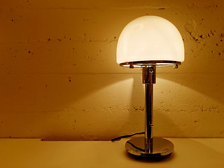 Image showing Table lamp giving warm orange light