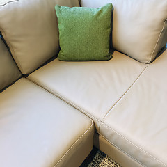 Image showing Gray corner sofa with green cushion