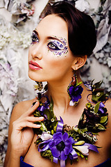 Image showing floral face art with anemone in jewelry, sensual young brunette 