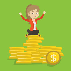 Image showing Happy business woman sitting on golden coins.