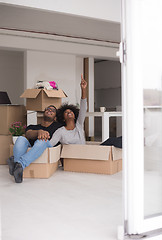 Image showing African American couple  playing with packing material