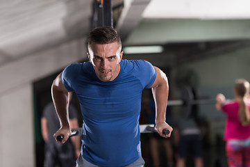 Image showing man doing exercises parallel bars