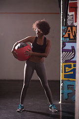 Image showing black woman carrying crossfit ball